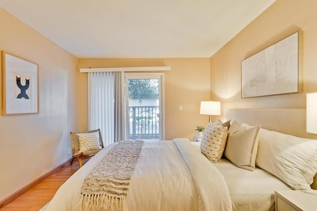 bedroom with wood-type flooring and access to exterior