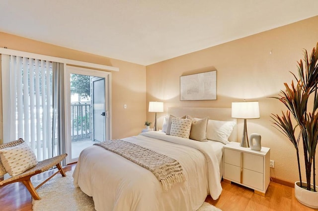 bedroom with light hardwood / wood-style floors and access to outside