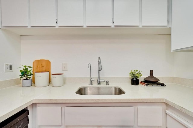 kitchen featuring sink, white cabinets, and dishwasher