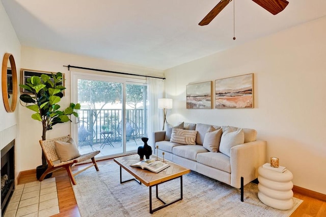 living room with light wood-type flooring and ceiling fan