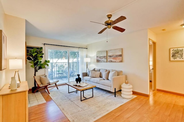 living room featuring wood-type flooring and ceiling fan