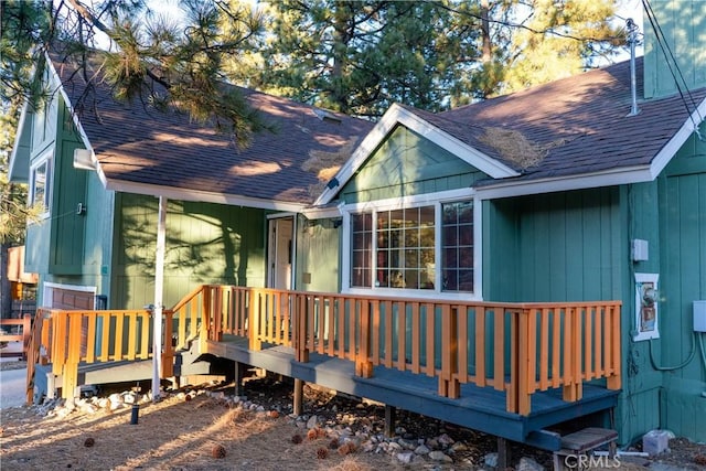 rear view of property featuring a deck