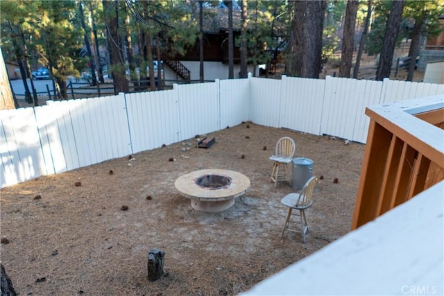 view of yard with a fire pit