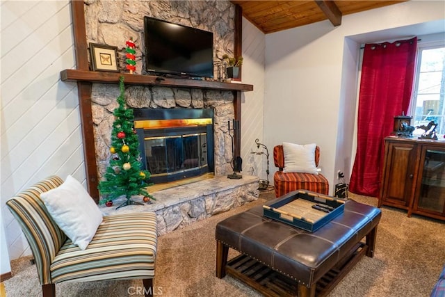 living room with lofted ceiling with beams, carpet floors, a fireplace, and wood ceiling