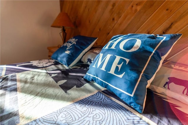 bedroom with wood walls