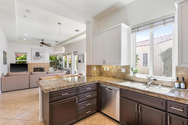 kitchen with kitchen peninsula, dishwasher, white cabinets, and dark brown cabinetry