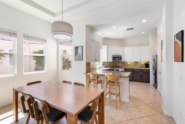 tiled dining space featuring sink