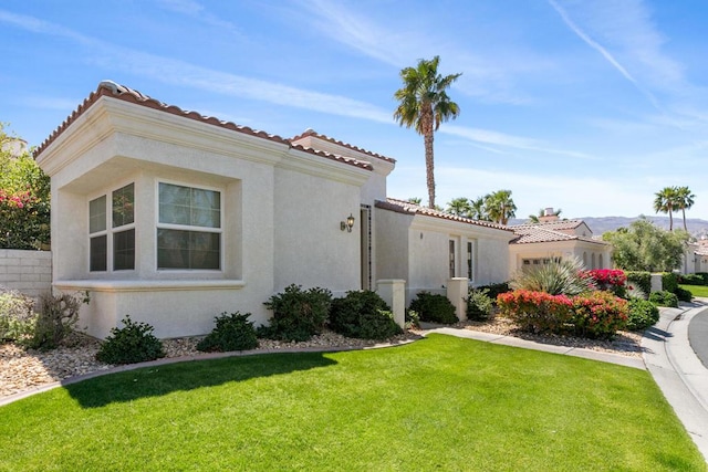 view of property exterior with a yard