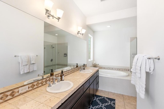 bathroom with vanity, tile patterned floors, and shower with separate bathtub