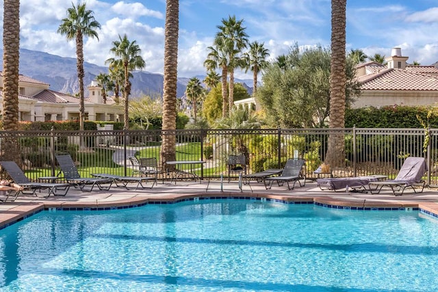 view of pool with a mountain view and a patio area