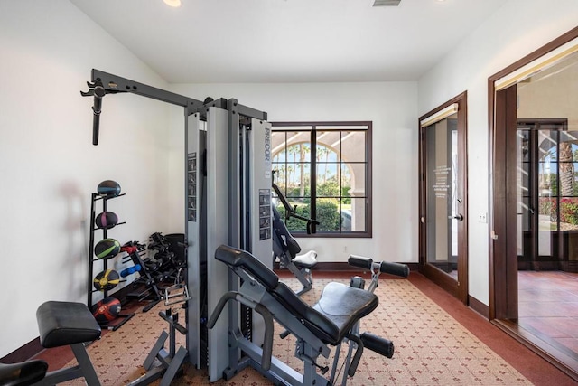 workout room with vaulted ceiling