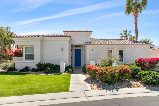 mediterranean / spanish-style home with a front lawn