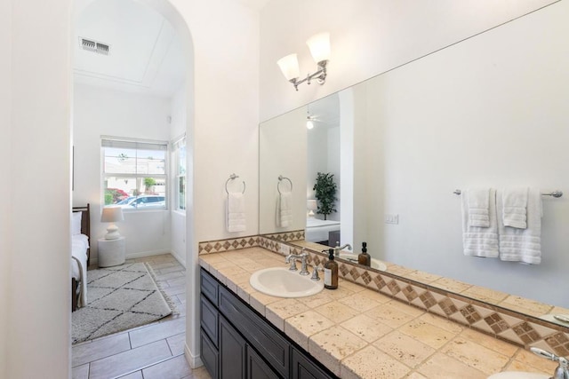 bathroom with ceiling fan, vanity, and tile patterned flooring