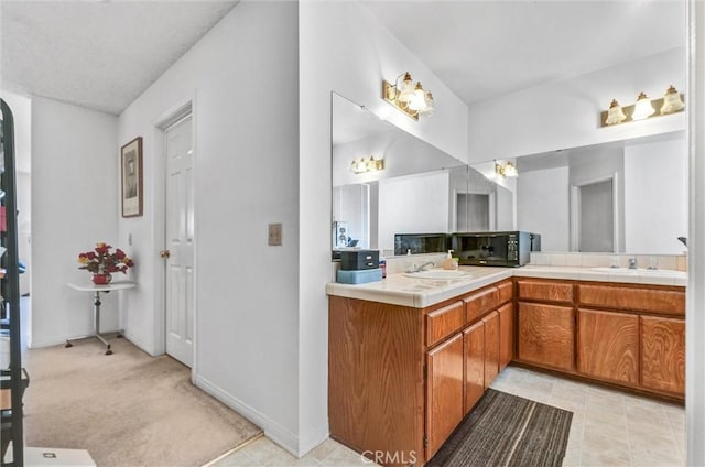 bathroom featuring tile patterned flooring and vanity