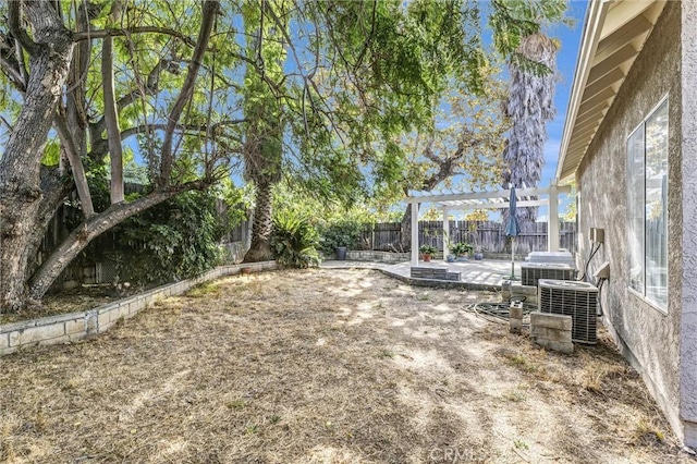 view of yard featuring central AC unit, a patio area, and a pergola