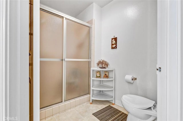 bathroom with toilet and a shower with shower door