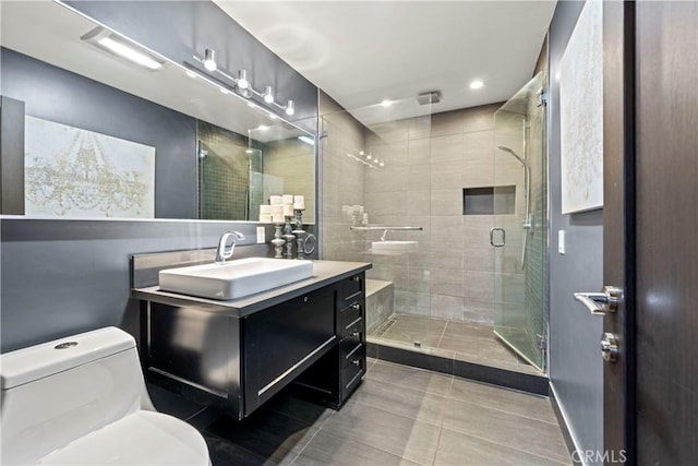 bathroom featuring tile patterned floors, vanity, toilet, and an enclosed shower