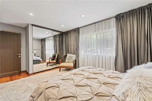 bedroom with a closet and hardwood / wood-style flooring