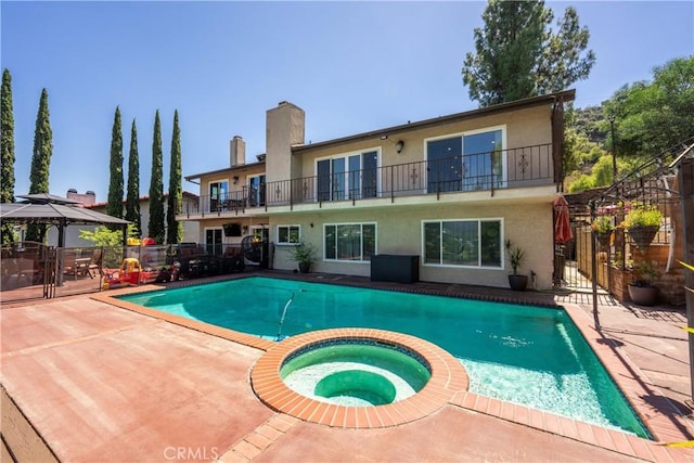 view of swimming pool featuring an in ground hot tub, a gazebo, and a patio