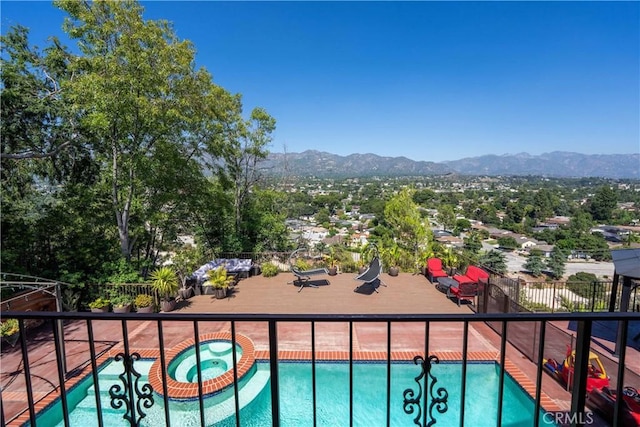 balcony with a mountain view and an in ground hot tub