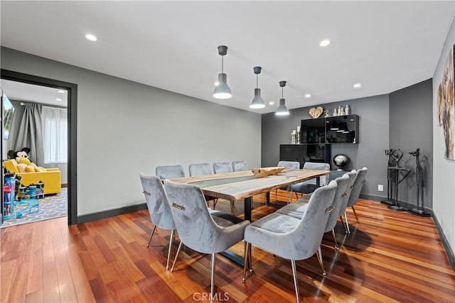 dining space featuring wood-type flooring