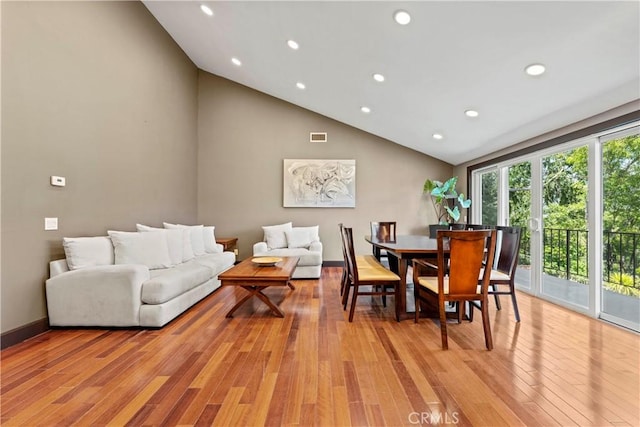 dining area featuring light hardwood / wood-style floors and high vaulted ceiling