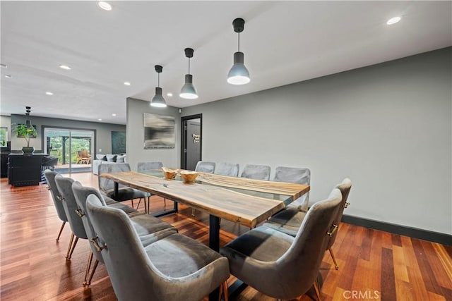 dining space with hardwood / wood-style floors