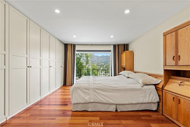 bedroom featuring light hardwood / wood-style floors and access to outside