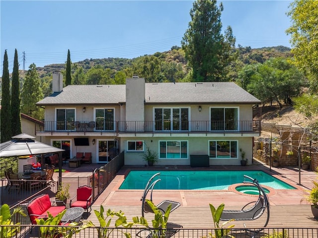 view of swimming pool featuring a gazebo, a patio area, and an in ground hot tub