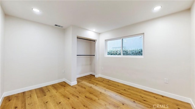 spare room with hardwood / wood-style flooring