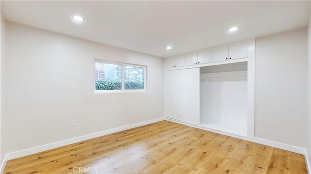 unfurnished bedroom featuring a closet and light hardwood / wood-style floors