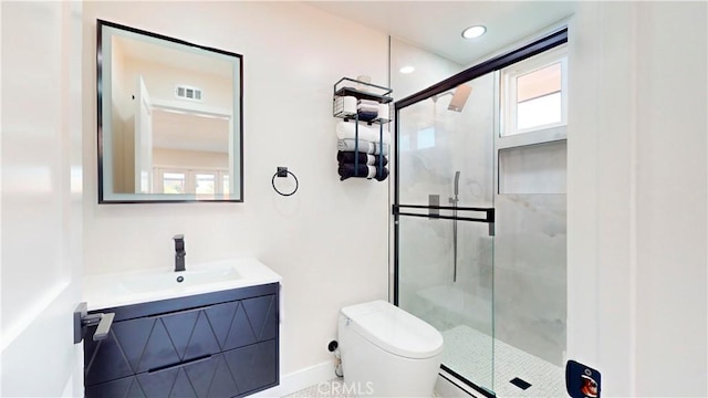 bathroom with toilet, vanity, and walk in shower