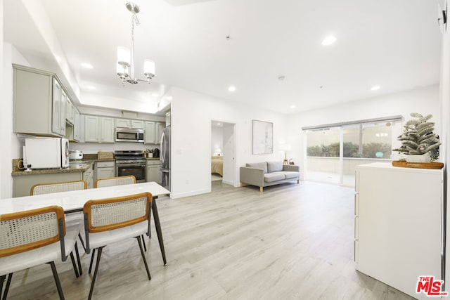 kitchen with stainless steel appliances, a notable chandelier, light hardwood / wood-style floors, decorative light fixtures, and gray cabinets