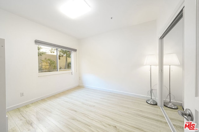 unfurnished room with light hardwood / wood-style floors