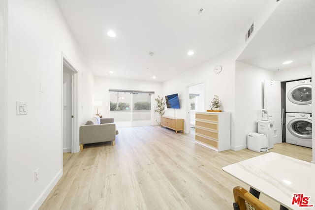 interior space featuring light wood-type flooring and stacked washing maching and dryer