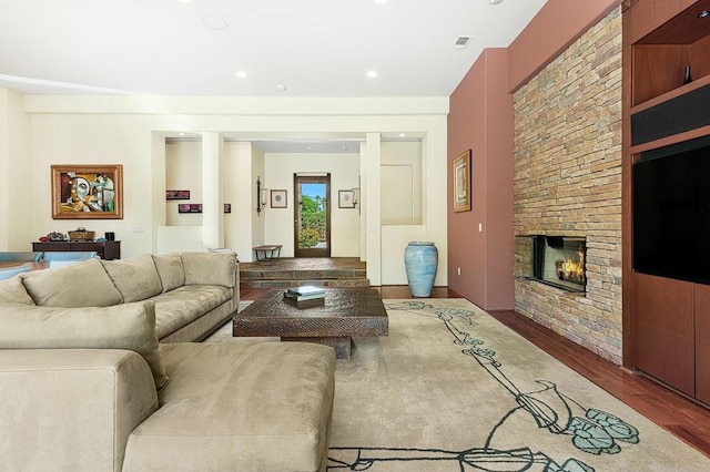 living room with a fireplace and hardwood / wood-style flooring