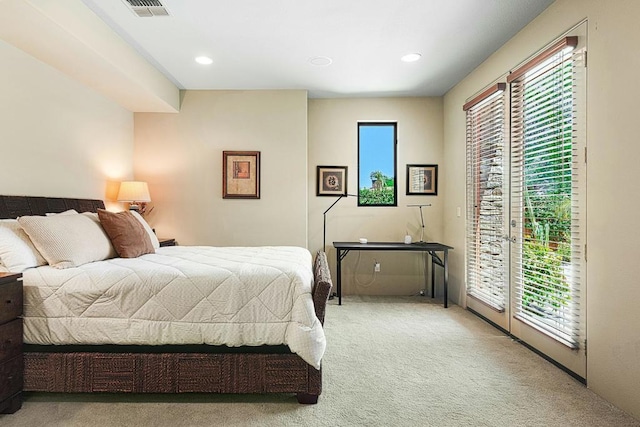 carpeted bedroom with access to exterior and multiple windows