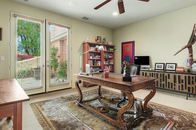 office featuring carpet flooring, ceiling fan, and a healthy amount of sunlight