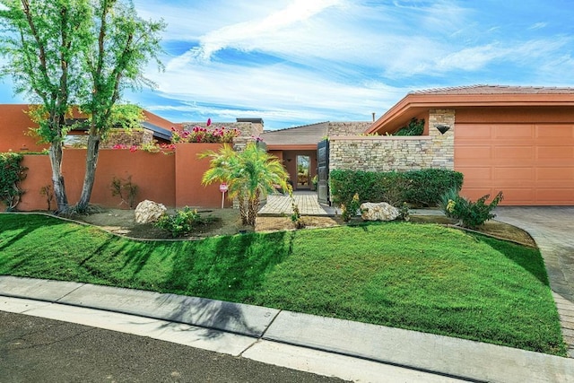 view of front facade with a garage and a front lawn