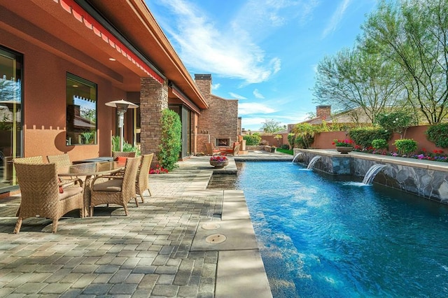 view of swimming pool with pool water feature and a patio area