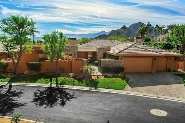 view of front of home with a mountain view and a garage