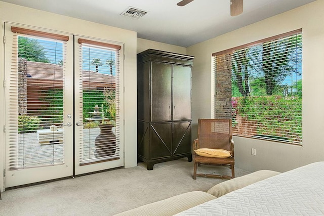 bedroom featuring light carpet, french doors, access to outside, and ceiling fan