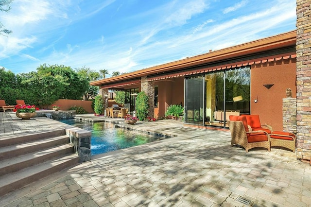 view of pool featuring pool water feature, a patio, and a jacuzzi