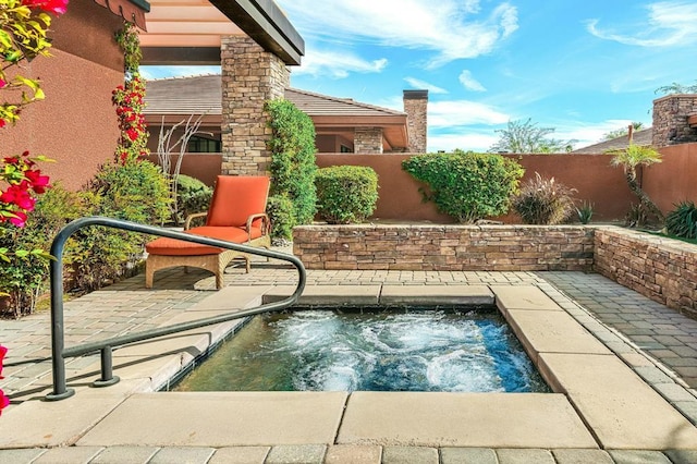 view of swimming pool featuring an in ground hot tub and a patio