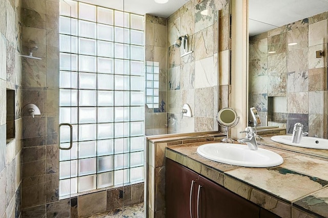 bathroom featuring vanity, tile walls, and walk in shower