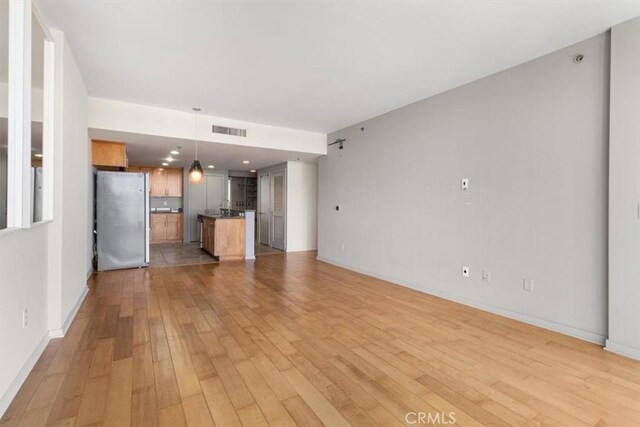 unfurnished living room with light hardwood / wood-style floors