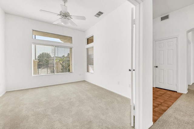 carpeted empty room featuring ceiling fan