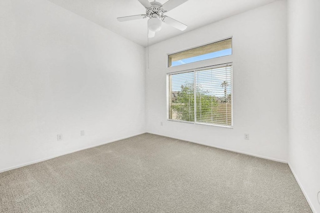 carpeted spare room featuring ceiling fan