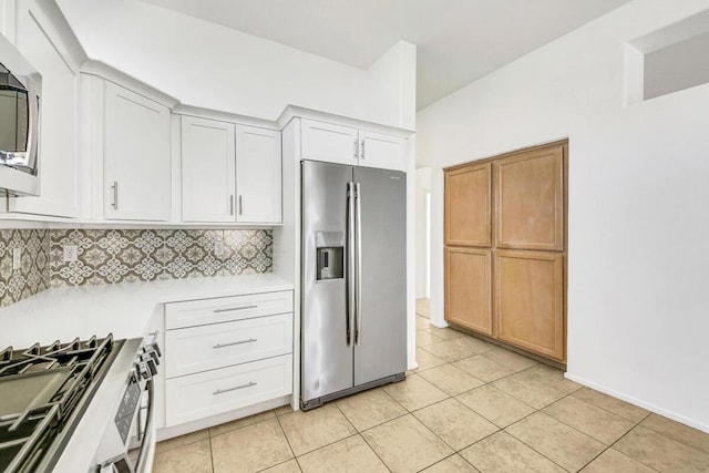 kitchen featuring decorative backsplash, light tile patterned floors, stainless steel appliances, and white cabinetry