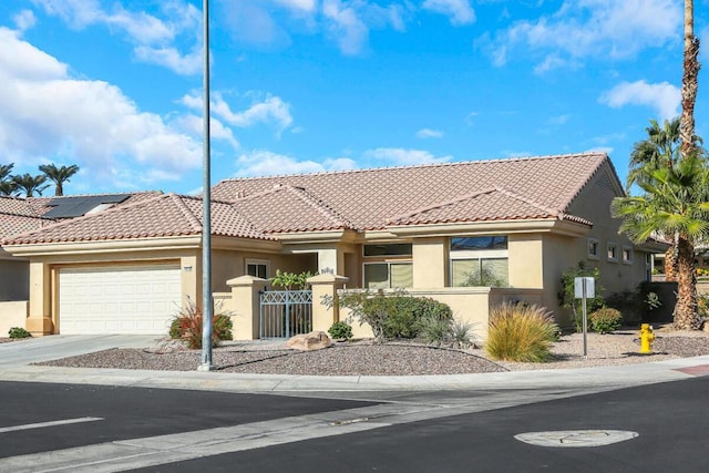 view of front of house featuring solar panels and a garage